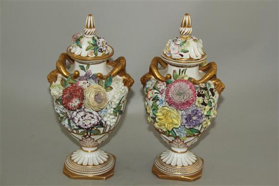 A pair of John Bevington floral encrusted twin handled vases, late 19th century, 24.5cm, damage to covers